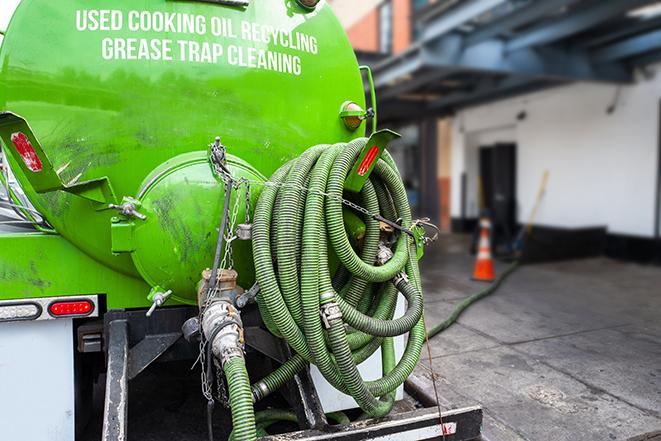 a professional technician pumping a restaurant's grease trap in Buellton, CA